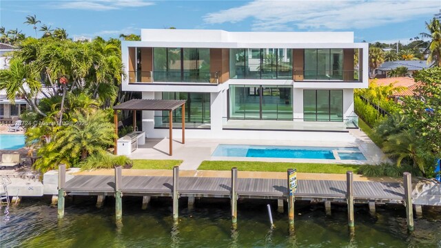 rear view of house featuring a water view and a patio