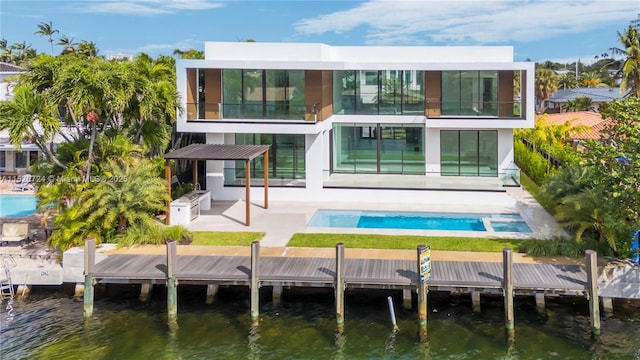 back of house with a patio, a water view, and a balcony