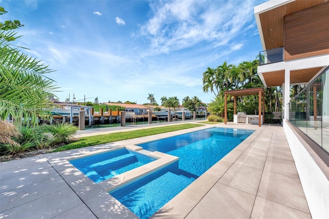 view of pool featuring a patio and an in ground hot tub