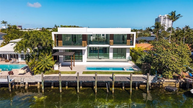 back of house with a patio area, a water view, and a balcony