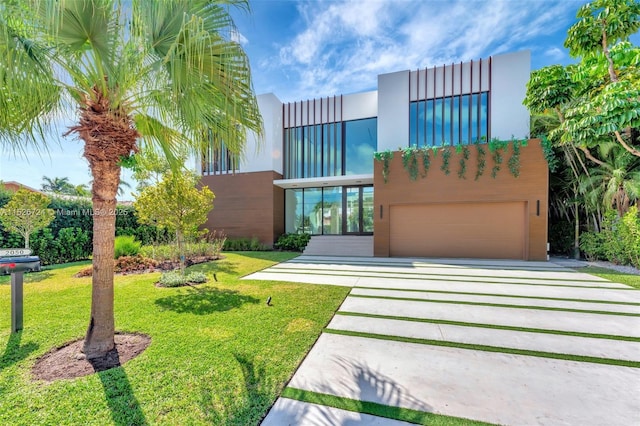 view of front of property with a front lawn and a garage