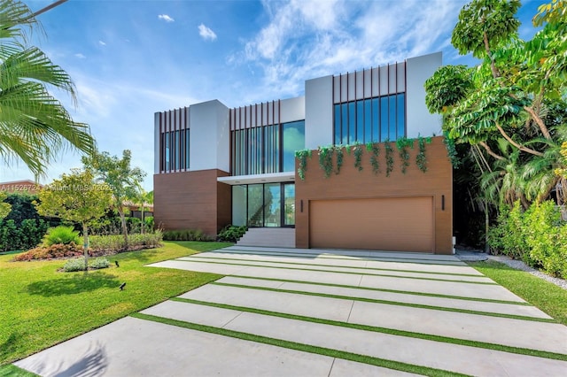 contemporary home with a garage and a front yard