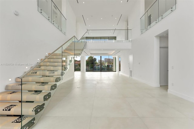 staircase featuring a towering ceiling