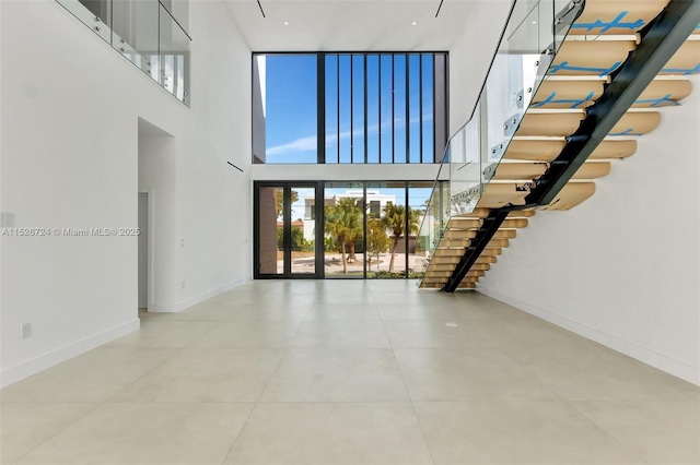 unfurnished living room with a high ceiling