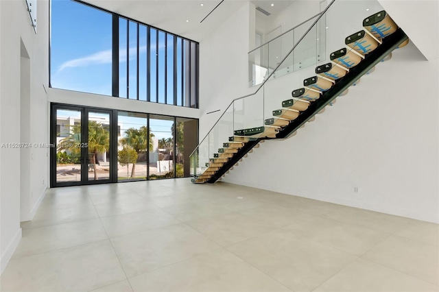 interior space featuring french doors and a towering ceiling