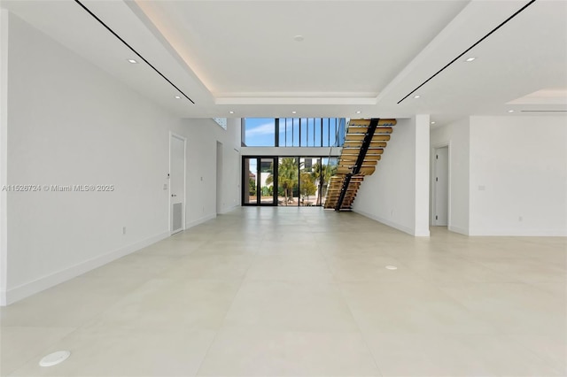 empty room with a high ceiling and a raised ceiling