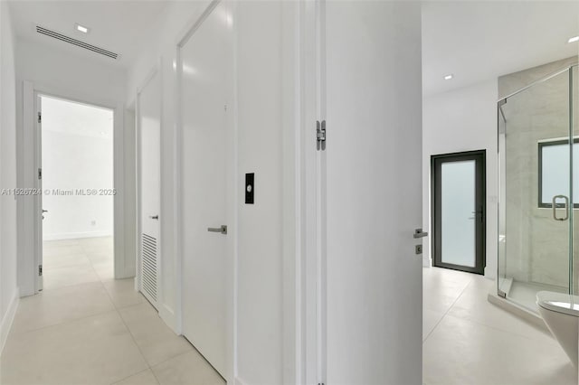 corridor featuring light tile patterned floors