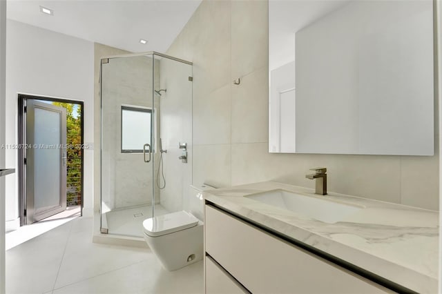 bathroom featuring tile walls, vanity, an enclosed shower, toilet, and tile patterned floors