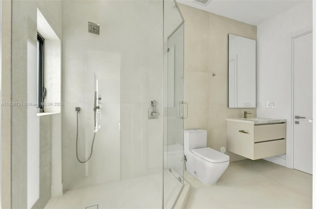 bathroom featuring vanity, toilet, and a shower with shower door