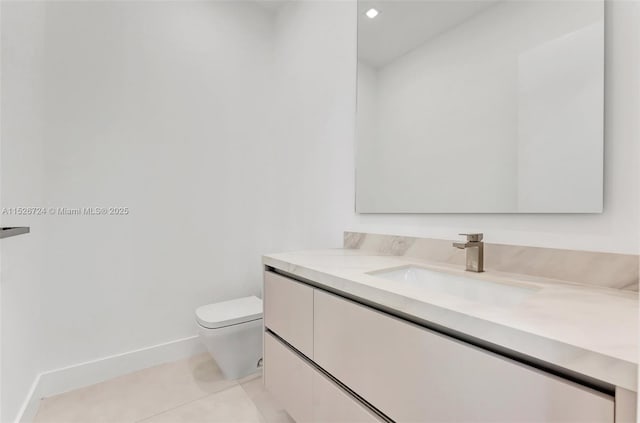 bathroom featuring toilet, vanity, and tile patterned flooring