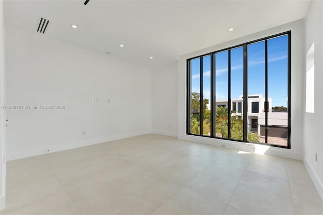 unfurnished room featuring light tile patterned flooring