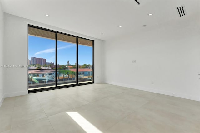 spare room featuring floor to ceiling windows