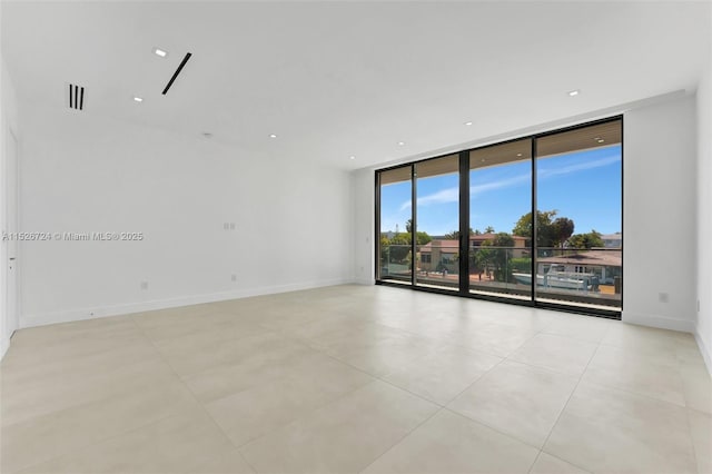 spare room with floor to ceiling windows