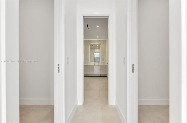 hall with light tile patterned floors