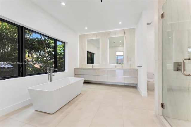 full bathroom with shower with separate bathtub, toilet, tile patterned flooring, and vanity