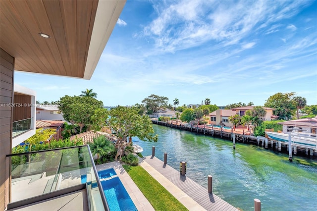 balcony featuring a water view and a dock