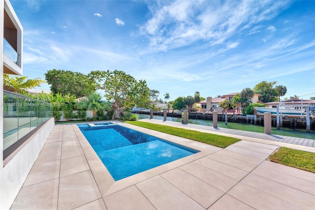 view of swimming pool featuring a dock and a water view