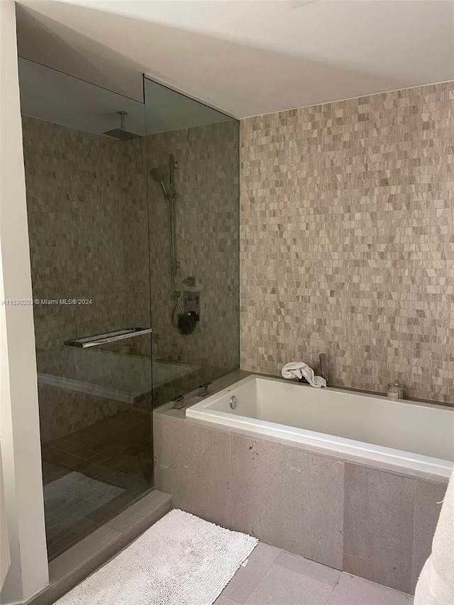 bathroom with plus walk in shower and tile patterned flooring