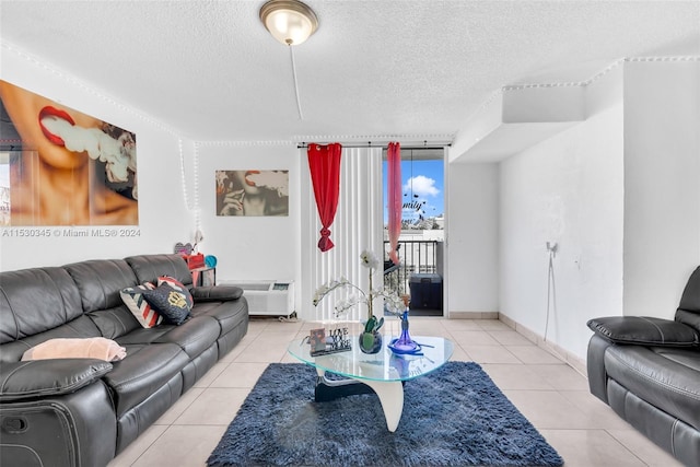 tiled living room featuring a textured ceiling