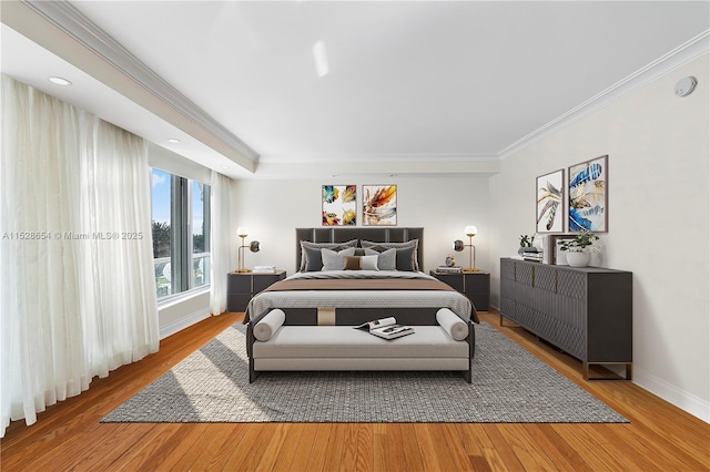 bedroom with wood-type flooring and ornamental molding