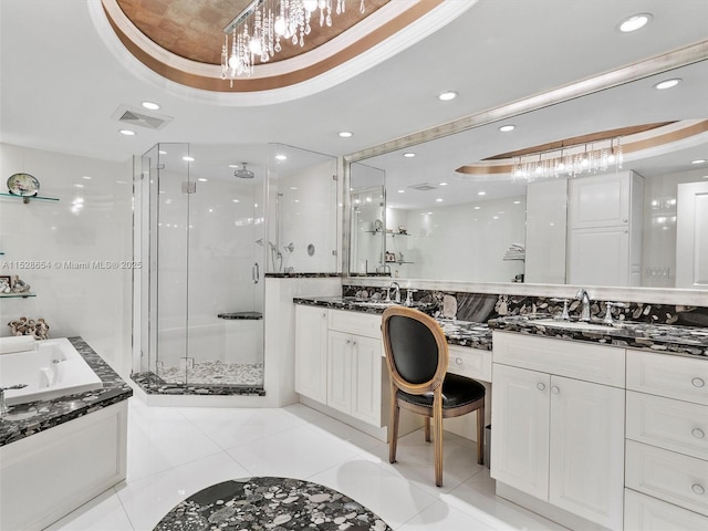 bathroom with tile patterned flooring, vanity, a tray ceiling, and plus walk in shower