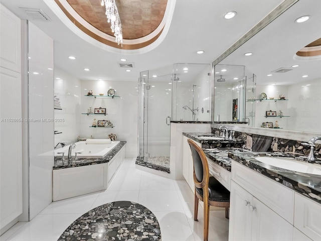 bathroom with vanity, tile patterned floors, a raised ceiling, and separate shower and tub