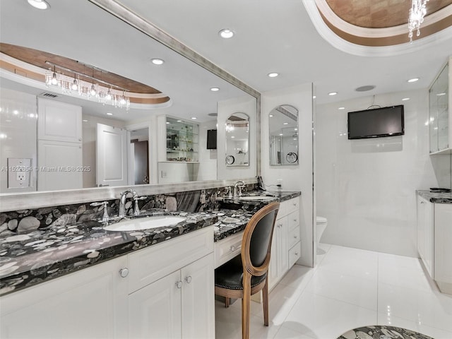 bathroom featuring vanity, tile patterned floors, a raised ceiling, toilet, and walk in shower