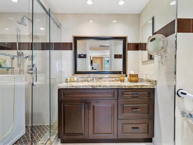 bathroom featuring walk in shower and vanity