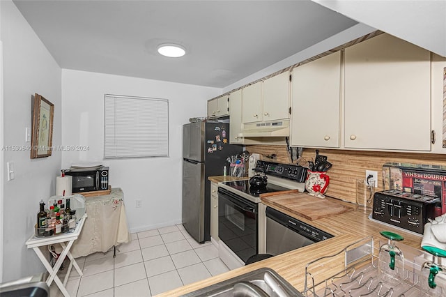 kitchen with light tile floors, appliances with stainless steel finishes, and white cabinetry