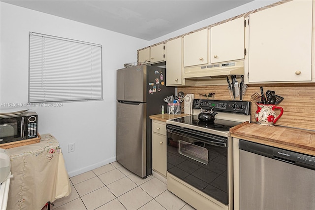 kitchen featuring appliances with stainless steel finishes and light tile floors