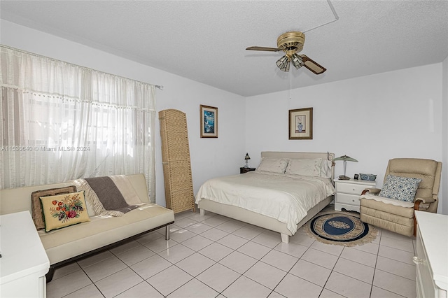 tiled bedroom with a textured ceiling and ceiling fan