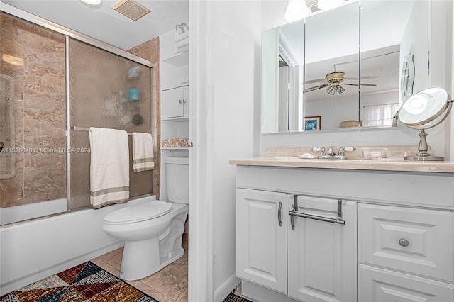 full bathroom featuring toilet, ceiling fan, tile flooring, shower / bath combination with glass door, and large vanity