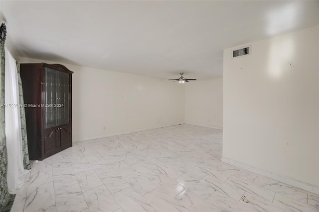 tiled empty room with ceiling fan