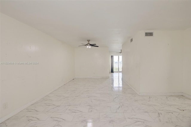 empty room featuring ceiling fan and light tile floors