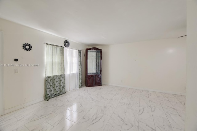 spare room featuring light tile floors