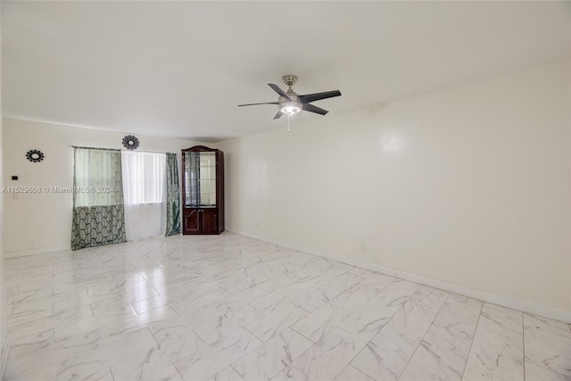 tiled spare room with ceiling fan