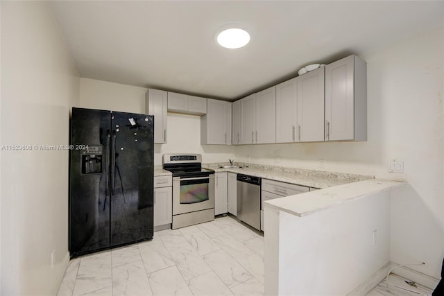 kitchen featuring kitchen peninsula, stainless steel appliances, light tile floors, and light stone counters