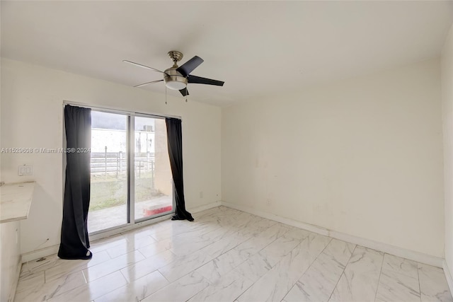 tiled empty room featuring ceiling fan