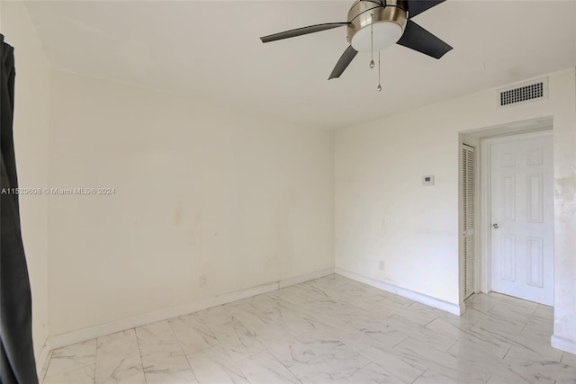 unfurnished room featuring ceiling fan and light tile floors