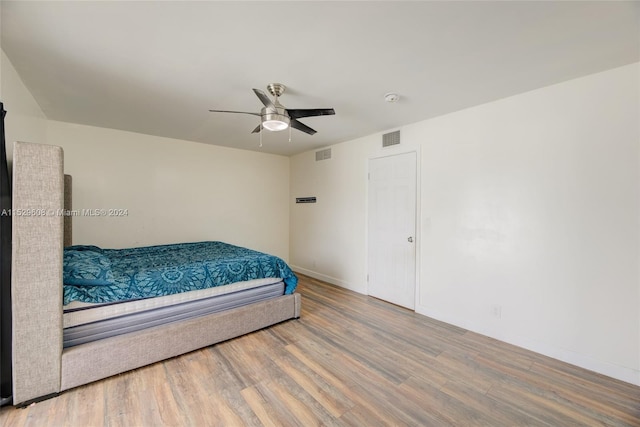 bedroom with ceiling fan and light hardwood / wood-style flooring