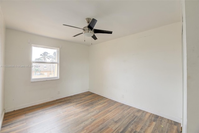 empty room with ceiling fan and wood-type flooring