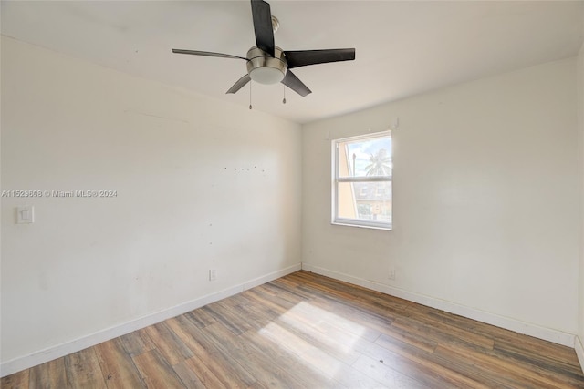 spare room featuring dark hardwood / wood-style flooring and ceiling fan