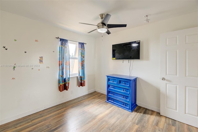 unfurnished bedroom with ceiling fan and light wood-type flooring