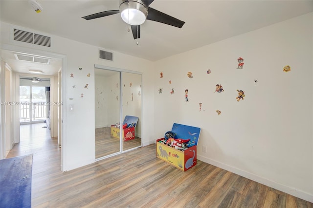 rec room with ceiling fan and light wood-type flooring