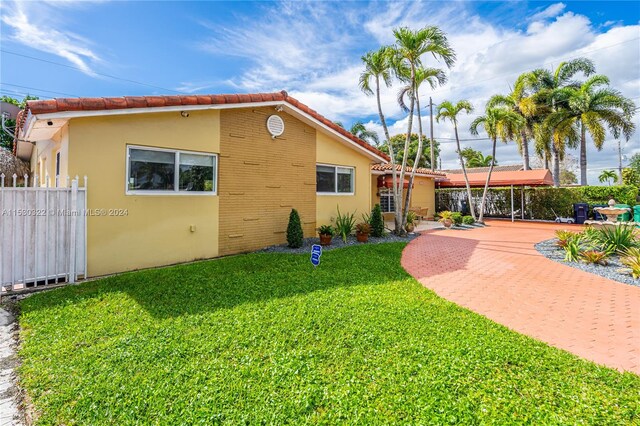 back of house featuring a yard and a patio