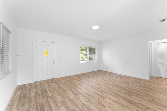 unfurnished living room featuring light wood-type flooring