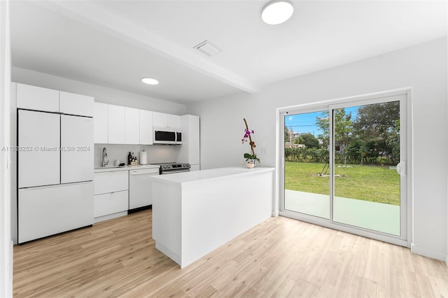 kitchen featuring appliances with stainless steel finishes, light hardwood / wood-style flooring, white cabinetry, and sink