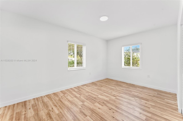 spare room with light hardwood / wood-style flooring