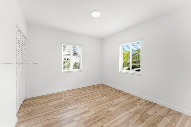 spare room with light wood-type flooring