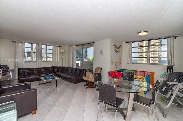 dining space featuring light tile patterned floors and a textured ceiling